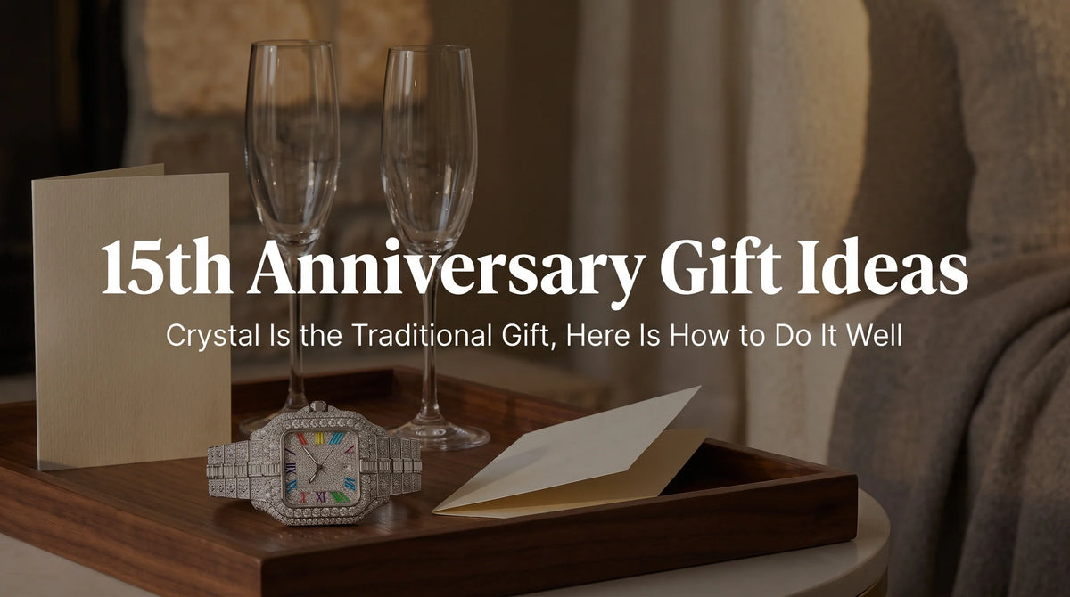 United Jewel The Mogul Rainbow iced out watch in Iced Crystal beside crystal flutes and an anniversary card