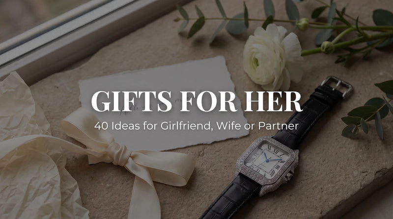 Liora Pearl Moissanite Watch beside ribbon, card and flowers in a gift flat-lay